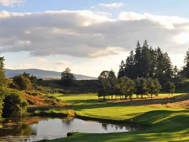 Scenic view of the Gleneagles golf course surrounded by trees and hills in Perthshire, Scotland, a popular luxury travel and tourism destination