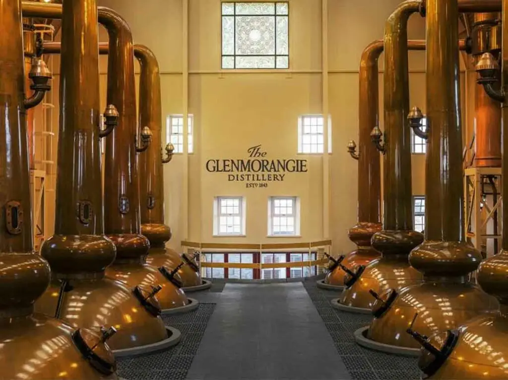 Copper stills inside Glenmorangie Distillery in Tain, Scotland, showcasing whisky production during a Scottish distillery tour