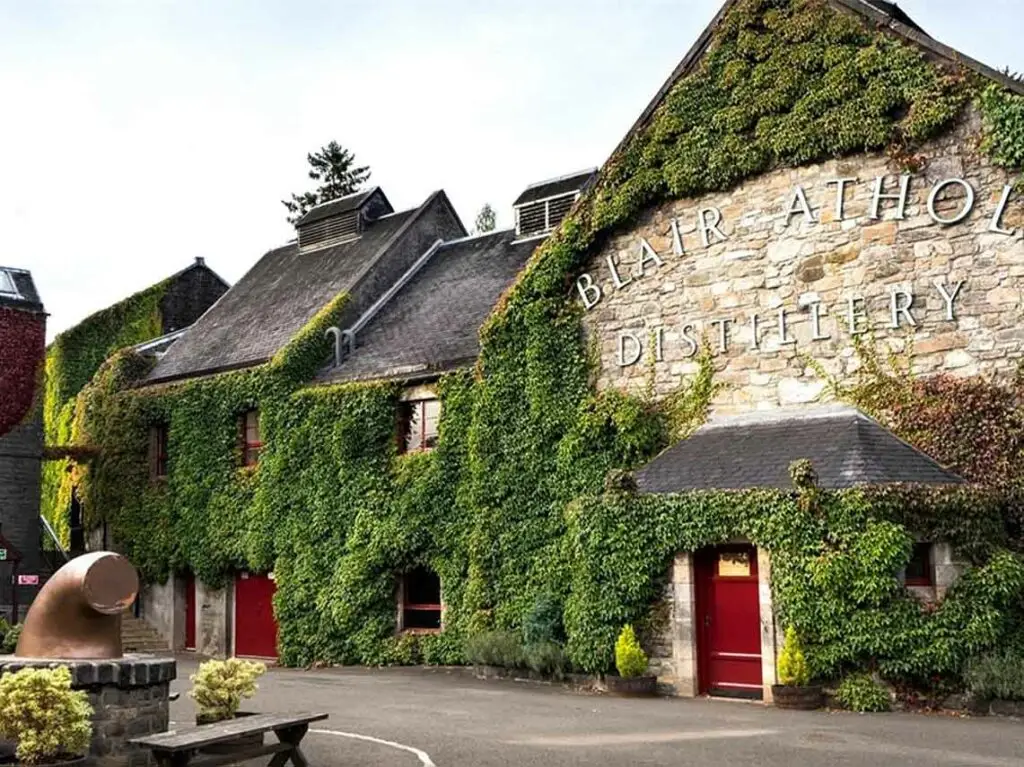 Blair Athol Distillery in Pitlochry, Scotland covered in green ivy, a popular whisky tourism destination and scenic attraction in the Scottish Highlands