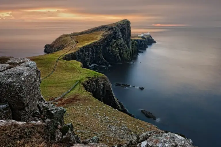 Dramatic coastal cliffs and lighthouse at Neist Point, Isle of Skye, Scotland, viewed from above at sunset, popular tourist attraction and scenic travel destination