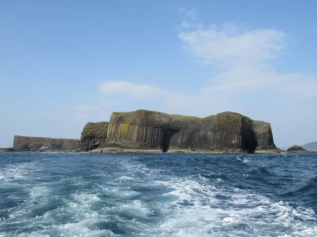 Fingal’s Cave on the Isle of Staffa, Scotland, viewed from the sea with basalt columns and ocean waves, popular Scottish tourist attraction and natural wonder