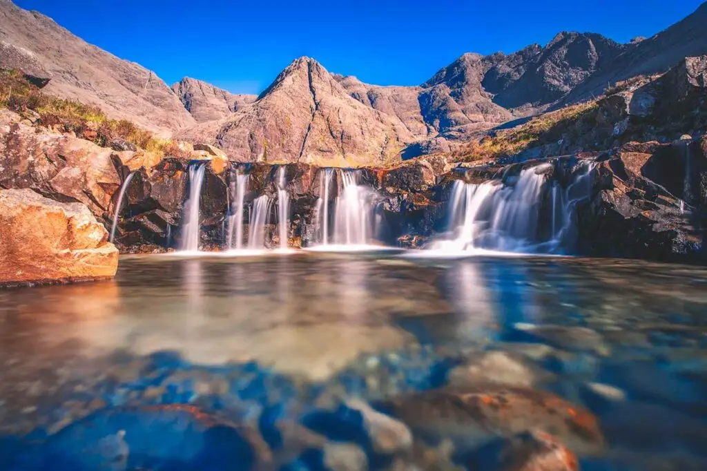 The Fairy Pools waterfalls and clear blue pools at the foot of the Cuillin Mountains on the Isle of Skye, Scotland, a popular Scottish tourist attraction and nature destination