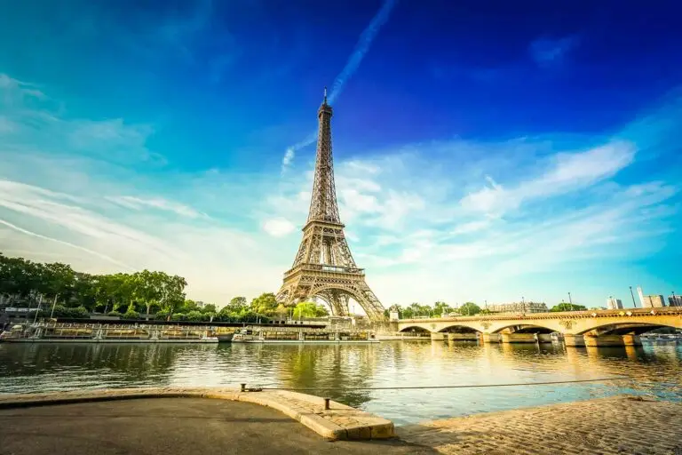 Eiffel Tower in Paris France viewed from the River Seine on a sunny day with blue sky and reflection in the water
