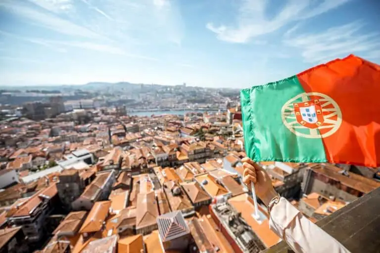 Aerial view of Porto old town with the Portuguese flag and Clerigos Tower, Portugal cityscape travel destination
