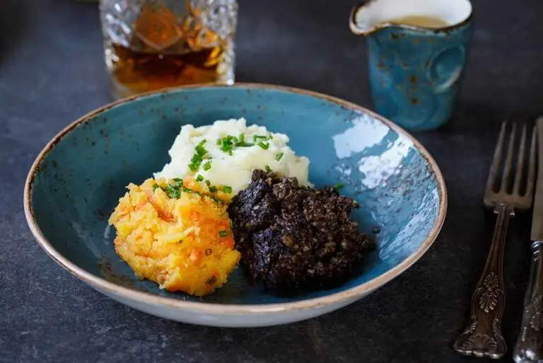 Traditional Scottish haggis with neeps and tatties served in a blue bowl, classic cuisine from Scotland United Kingdom