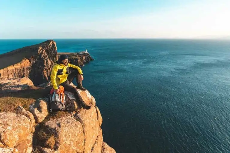 Man sitting atop Skye Cliff, Hiking, Scotland