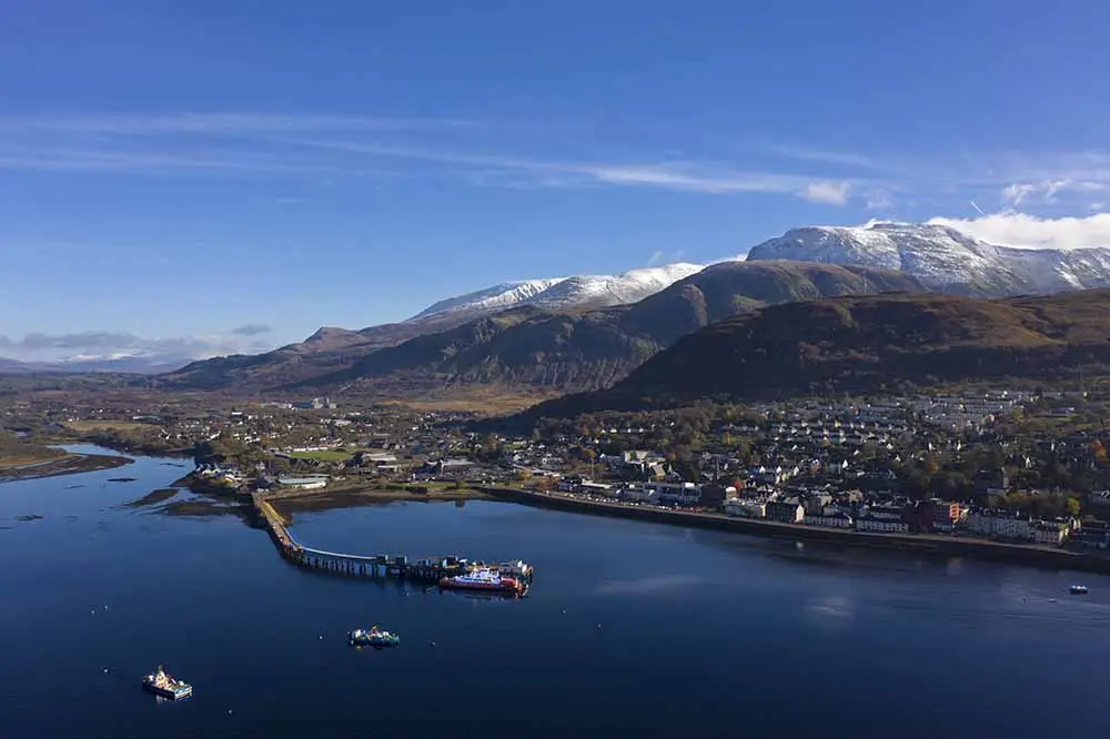 Aerial view of Fort William, Scotland with Ben Nevis mountain in the background, featured on a private driver-guided tour of the Scottish Highlands.