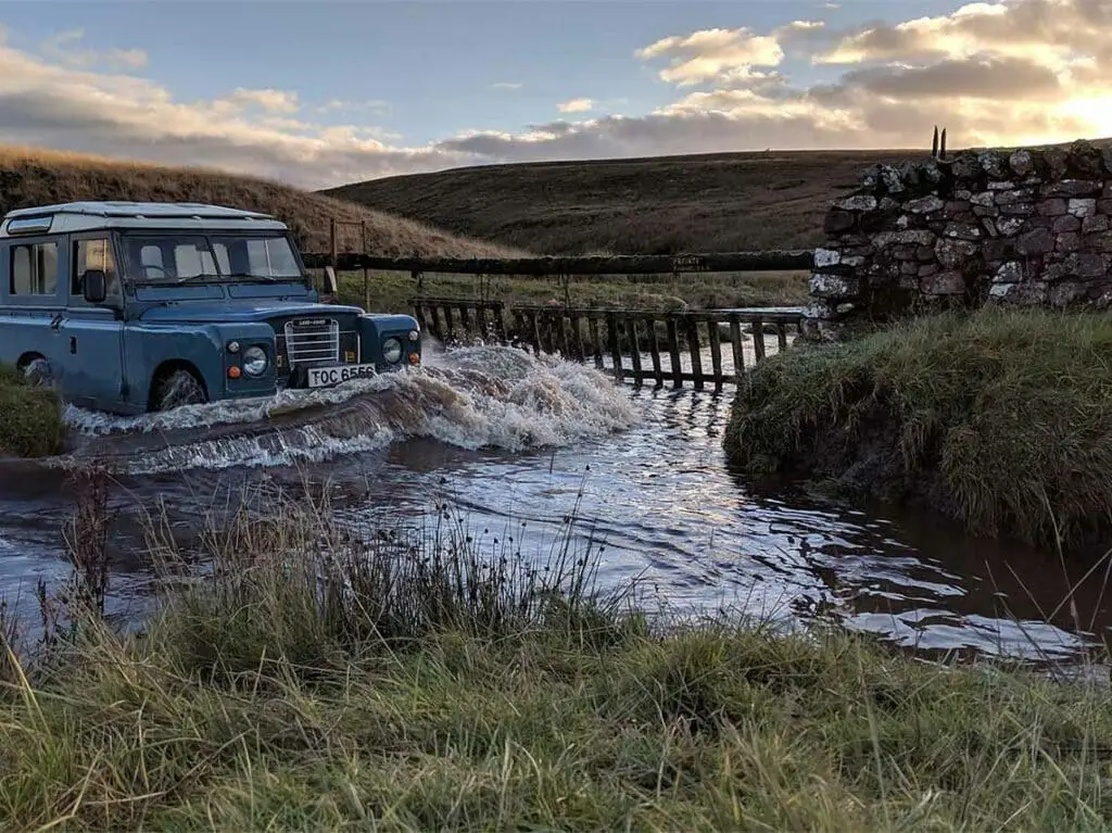 Land Rover driving through a river on a Highland Safari adventure in the Scottish Highlands, Scotland
