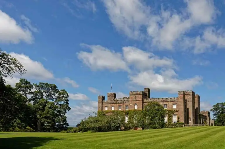 Scone Palace in Perth Scotland historic landmark and popular tourist attraction surrounded by gardens and green landscape under blue sky