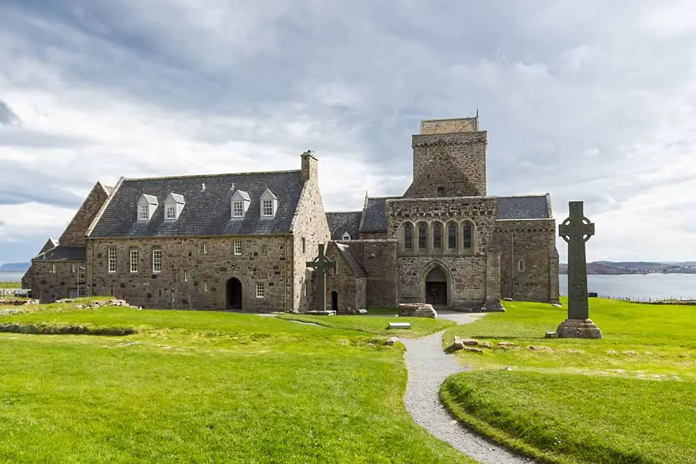 Iona Abbey on the Isle of Iona in Scotland, a historic stone monastery and popular tourist attraction overlooking the sea