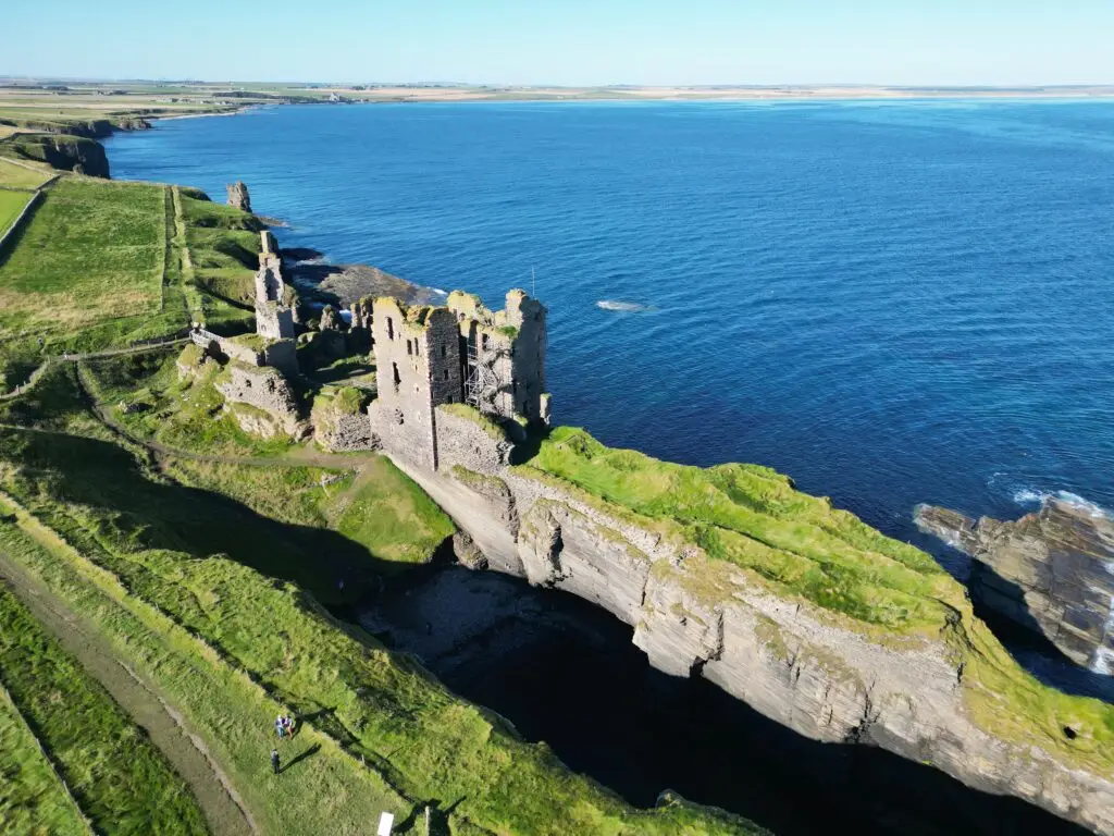 High angle view of Castle Sinclair Girnigoe ruins on the Caithness coast near Wick, Scotland, overlooking the North Sea on a clear day