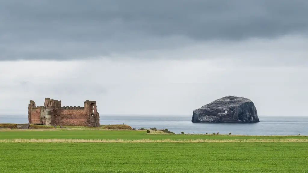 Tantallon Castle overlooking the sea with Bass Rock in the distance near North Berwick, Scotland, historic coastal landmark and popular Scottish tourism attraction