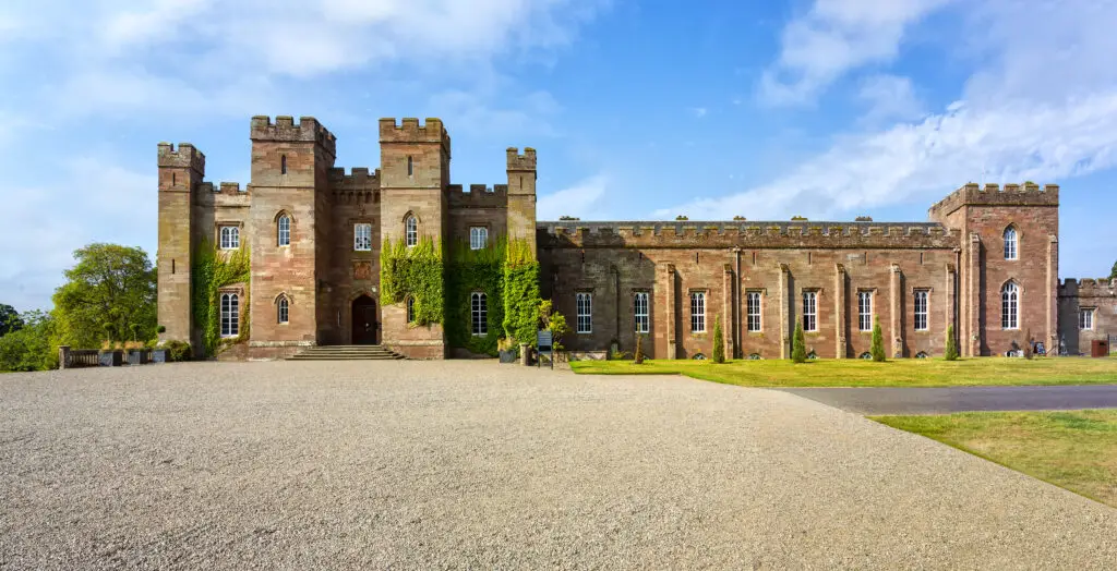 Scone Palace in Perth, Scotland, historic red sandstone castle surrounded by gardens and lawns, popular tourist attraction and heritage site featured on Braw Scottish Tours