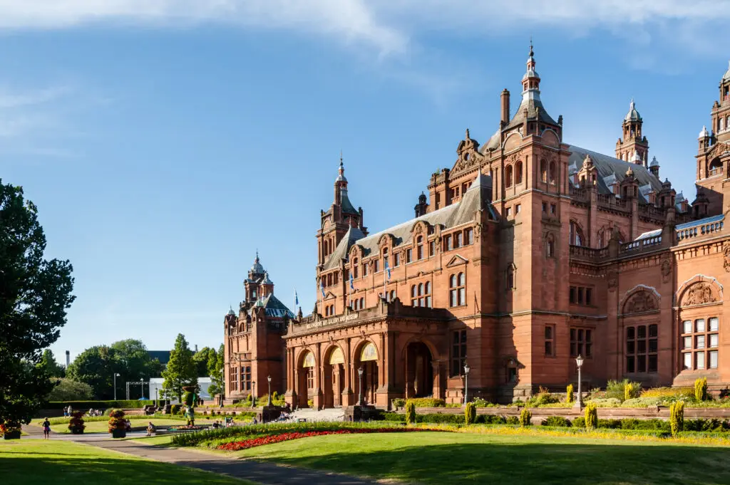 Kelvingrove Art Gallery and Museum in Glasgow, Scotland, a popular tourist attraction with stunning red sandstone architecture and landscaped gardens