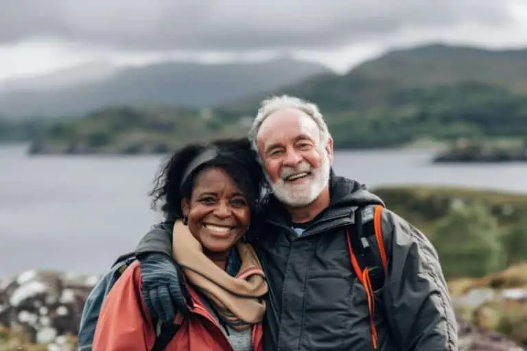 Smiling couple enjoying a scenic view of the Scottish Highlands, Scotland during a guided outdoor tour with Braw Scottish Tours